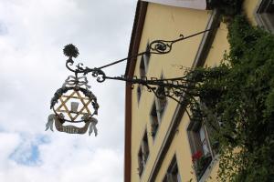 a street light hanging from the side of a building at Gasthof Butz in Rothenburg ob der Tauber
