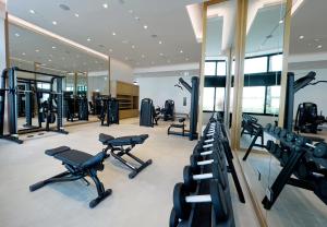 a gym with a lot of treadmills and machines at KeyHost - The Address Beach Residence - K1360 in Dubai