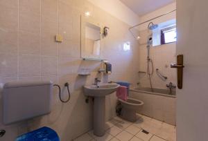 a bathroom with a sink and a toilet and a shower at Apartment below the stars in Rovinj +30 photos