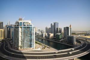 a city with a highway in front of a city at KeyHost - The Address Beach Residence - K1360 in Dubai
