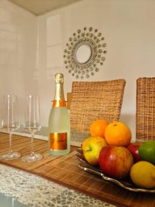 a bottle of wine and some fruit on a table at Ferienwohnung Toni mit Balkon und Garten in Pemfling