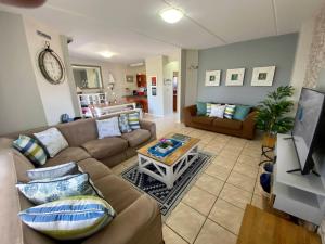 a living room with a couch and a table at Santa Maria -Langebaan Country Estate in Langebaan