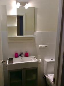 a bathroom with a sink and a mirror at Santa Barbara Guesthouse in Alicante