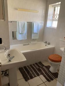 a bathroom with a tub and a toilet and a sink at Dolphin View 402 Margate in Margate