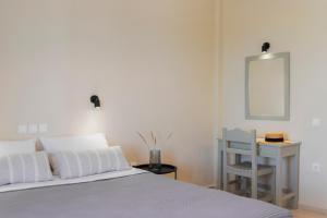 Postel nebo postele na pokoji v ubytování Kamini Apartments