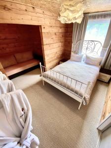 マンジェロクにあるHotel Malinaのベッドと窓が備わる小さな客室です。