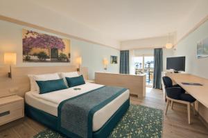 A bed or beds in a room at La Blanche Resort & Spa