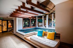a swimming pool with a couch in the middle of a house at C Mauritius in Belle Mare