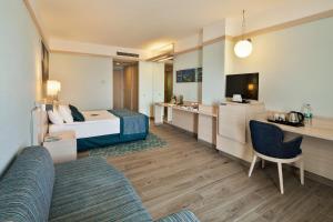 A television and/or entertainment centre at La Blanche Resort & Spa