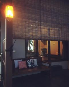 a living room with a couch and a window at Jasmine & Tea House in Mae Nam