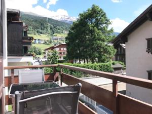 a balcony with a chair and a view of a mountain at Chalet Bormino in Bormio