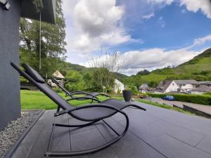a group of chairs sitting on a patio at Ferienwohnung Ida in Traben-Trarbach +10 photos