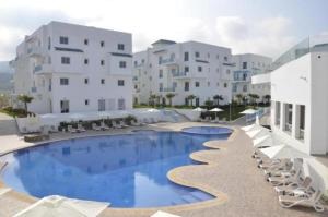 a large swimming pool in front of a building at APPART SMIR PARK in Tétouan