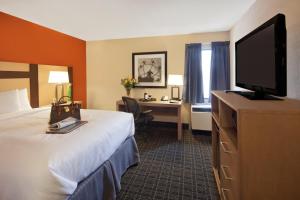
a hotel room with two beds and a television at Canadas Best Value Inn Toronto in Toronto
