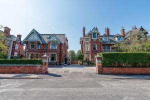 a large red brick house with a driveway at Clementine's Town House Hotel BW Premier Collection in York