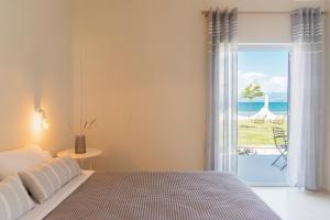 Postel nebo postele na pokoji v ubytování Kamini Apartments