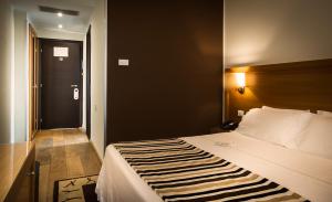 Postel nebo postele na pokoji v ubytování Sardegna Hotel - Suites & Restaurant