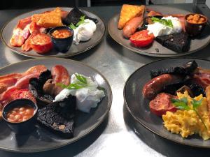 four plates of different types of food on a table at The Scotts Arms Village Inn in Sicklinghall