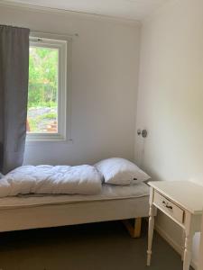 a bedroom with a bed with a window and a desk at Big house in amazing Napp, Lofoten in Napp