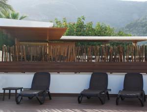 
a row of chairs sitting on top of a patio at Hotel Santamarta in Cullera

