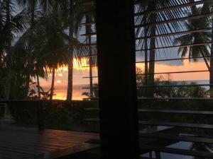 a sunset seen through a window of a house at Jasmine & Tea House in Mae Nam