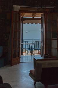 a living room with a door open to a balcony at Evimeria Kalamata in Kalamata