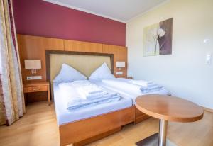 a bedroom with a bed, desk, chair, and lamp at Mühlengarten by Relax Inn - Fully Digital & Self Check-In in Nittel