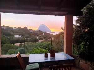 a table on a balcony with a view of a mountain at Eleni Room in Costa Dorata