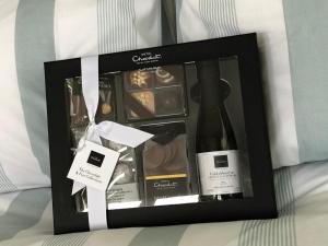 a gift box with a bottle of wine and chocolates at The Stables @ The Forge Cronk Y Voddy in Saint Johns