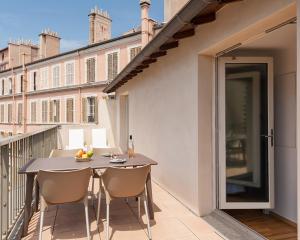 a balcony with a table and chairs on a balcony at Residhotel Vieux Port in Marseille