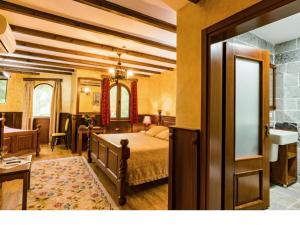 a bedroom with a bed and a sink in a room at Hotel Castle Park in Berat