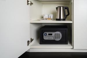 a microwave in a cabinet in a kitchen at Hotel C Stockholm in Stockholm