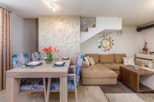 a living room with a table and a couch at Holiday house Lucija in Žgaljić