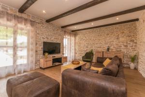 a living room with a brick wall at Villa Vitis ZadarVillas in Oklaj +28 photos