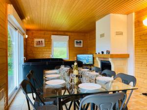 a dining room with a long table and chairs at Chalet Myrtille in Gérardmer