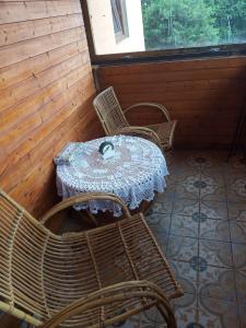 a table and chairs in a room with a table and a window at chata FRIDAY in Ktová +19 photos