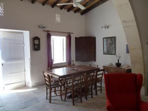 a dining room with a wooden table and chairs at To Archontiko tis Anastasias in Athienou