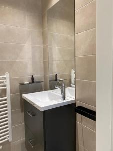 a bathroom with a sink and a mirror at Chalet Manhattan in Gérardmer