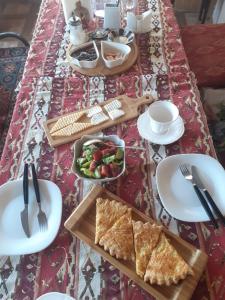 葉瑞文的住宿－Mini-Hotel Şara Talyan and Tours，顶上摆有盘子和碗的食物的桌子