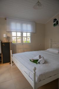 a bedroom with a white bed with a towel on it at Sea View Residence in Néa Kíos