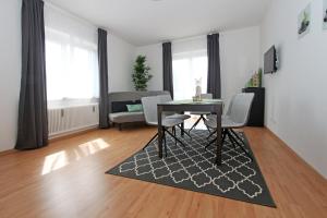 a living room with a table and chairs and a couch at Steira-Studios Leibnitz in Leibnitz