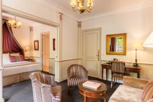 une chambre d'hôtel avec un lit et un canapé dans l'établissement Hôtel Napoleon Paris, à Paris