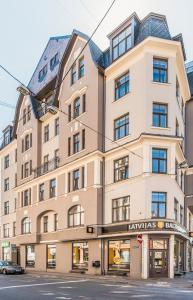 a large building on the corner of a street at Cozy Modern Studio - Great for Short Trips in Riga