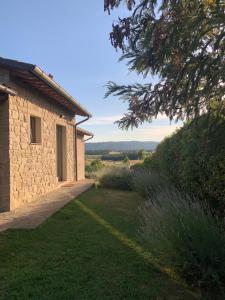 a stone house with a view of the countryside at Nonno Gino suite in Monte San Savino