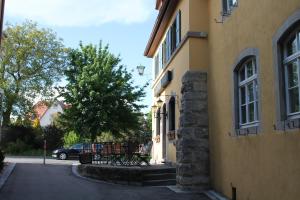 a bench sitting outside of a building next to a building at Hotel Gasthof zur Linde in Rothenburg ob der Tauber