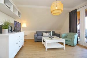 a living room with a couch and a table at An der Steilküste Wohnung 03 in Boltenhagen