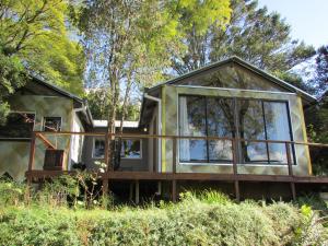 a house with a large window on the side of it at Karkloof Hideout in Howick