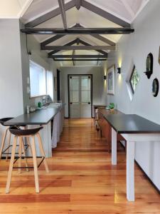 a kitchen with black counter tops and wooden floors at Karkloof Hideout in Howick