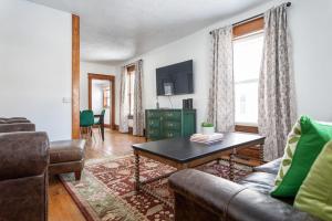 a living room with a couch and a coffee table at The Blue House on Front Downtown Traverse City in Traverse City