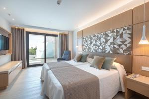 a hotel room with a large bed and a television at Hipotels Barrosa Park in Chiclana de la Frontera +37 photos